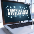 Laptop with the words "Training and Development" on the screen.